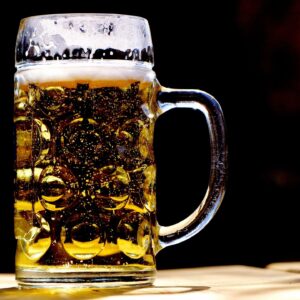 Glass stein filled with frothy beer